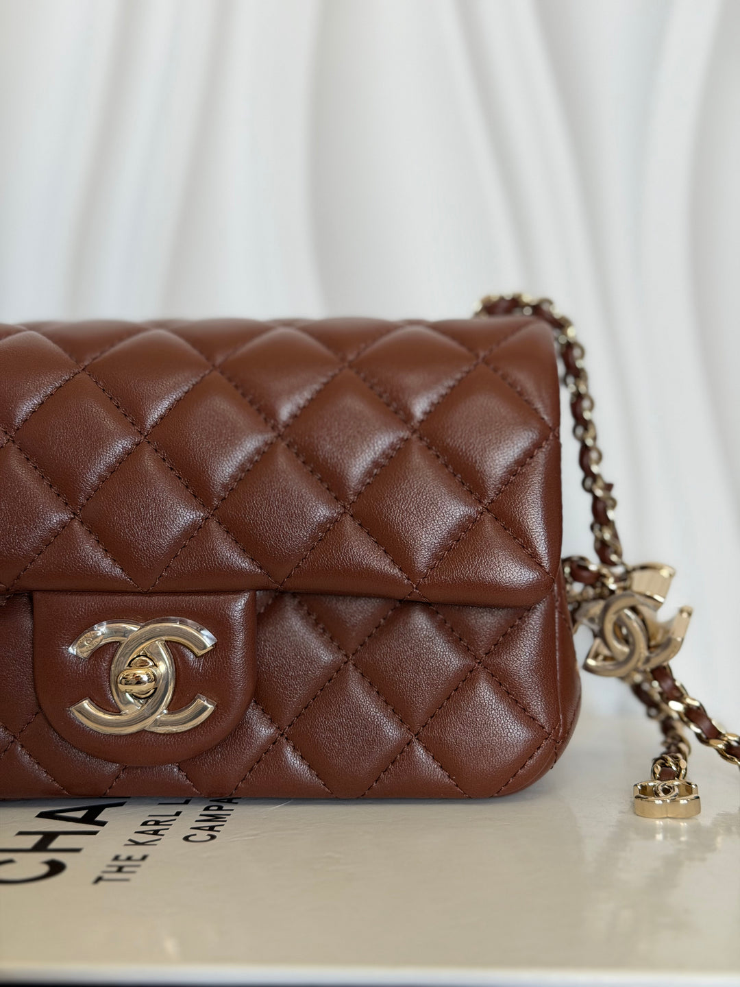 CHANEL 26S Brown Lambskin Adjustable Chain LGHW Mini Rectangular Flap Bag 2026