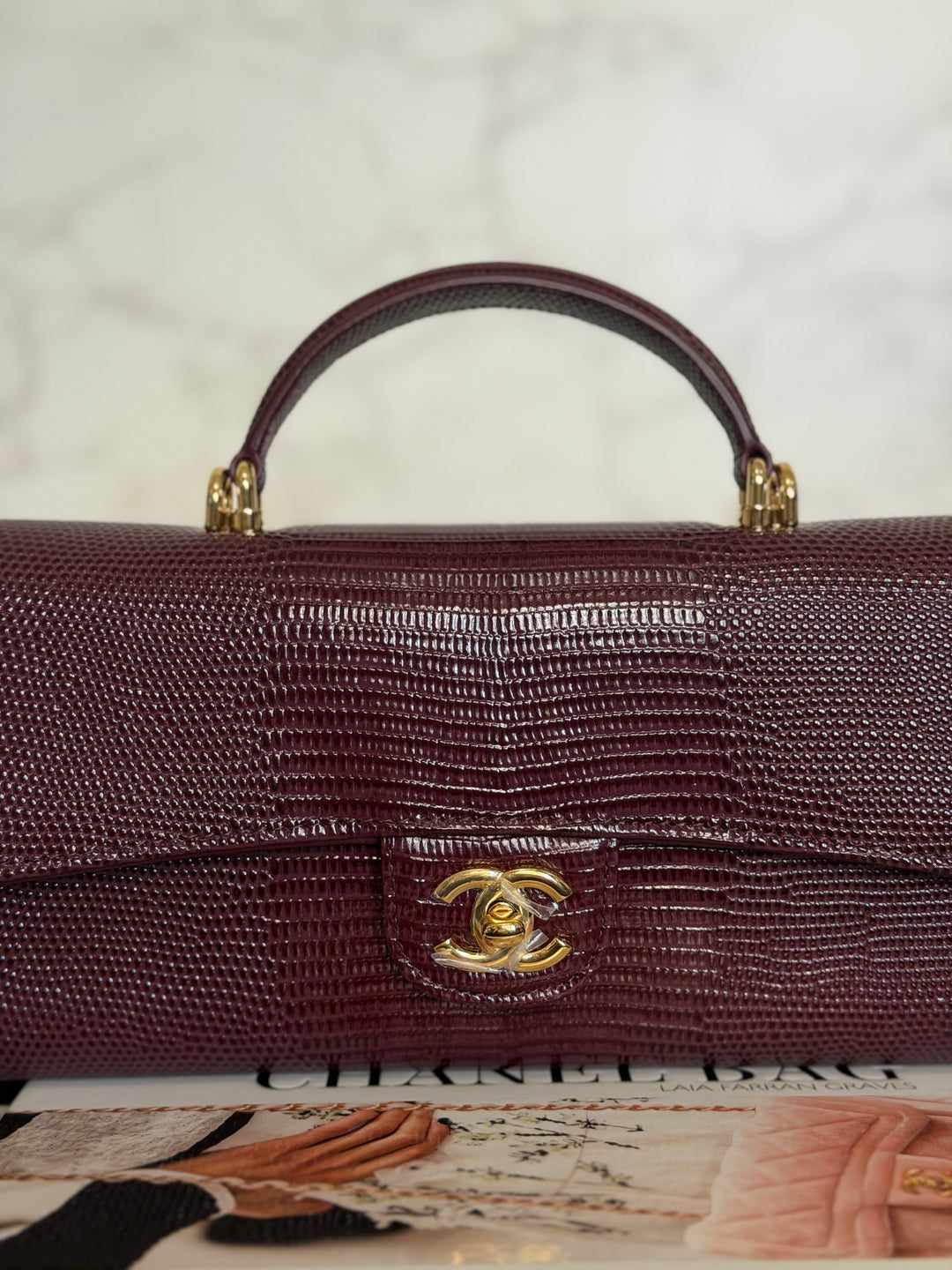 CHANEL 26A Matthieu Blazy Clutch with Top Handle in Burgundy Lizard-Embossed Calfskin with Light Gold Hardware 2026