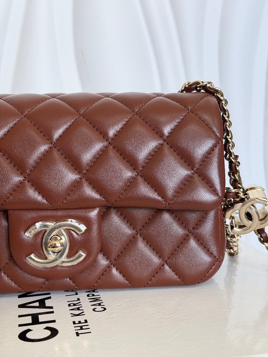 CHANEL 26S Brown Lambskin Adjustable Chain LGHW Mini Rectangular Flap Bag 2026
