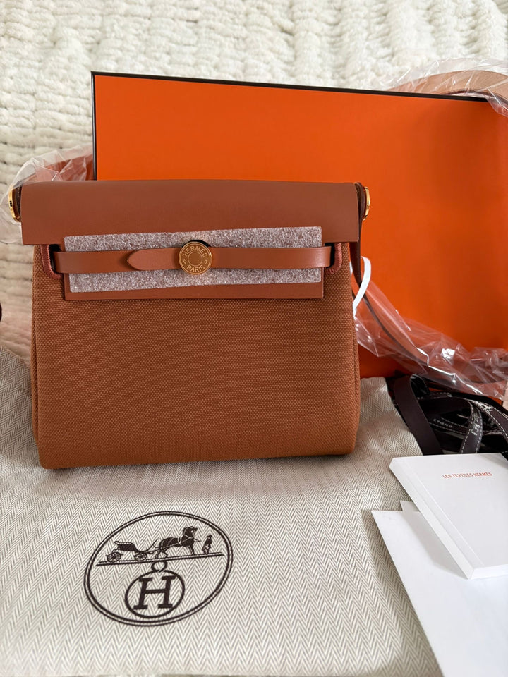Hermès Gold Vache Hunter and Toile Mini Herbag Zip 20 Gold Hardware, 2026