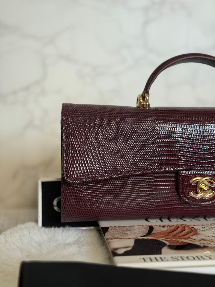 CHANEL 26A Matthieu Blazy Clutch with Top Handle in Burgundy Lizard-Embossed Calfskin with Light Gold Hardware 2026