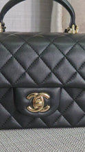 Load and play video in Gallery viewer, Chanel Black Lambskin Top Handle Mini Rectangular Flap Bag with Champagne GHW
